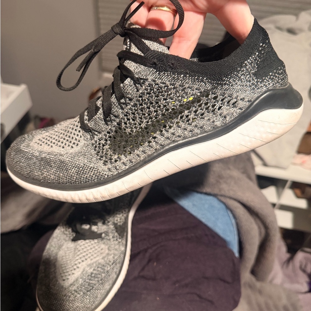 Nike Womens Gray and Black Flyknit Athletic Shoes with Subtle Yellow Swoosh